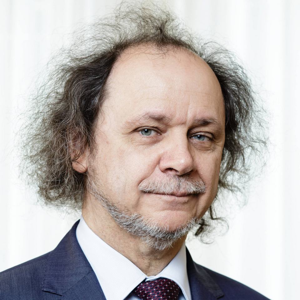 male face with long and curly hair and beard